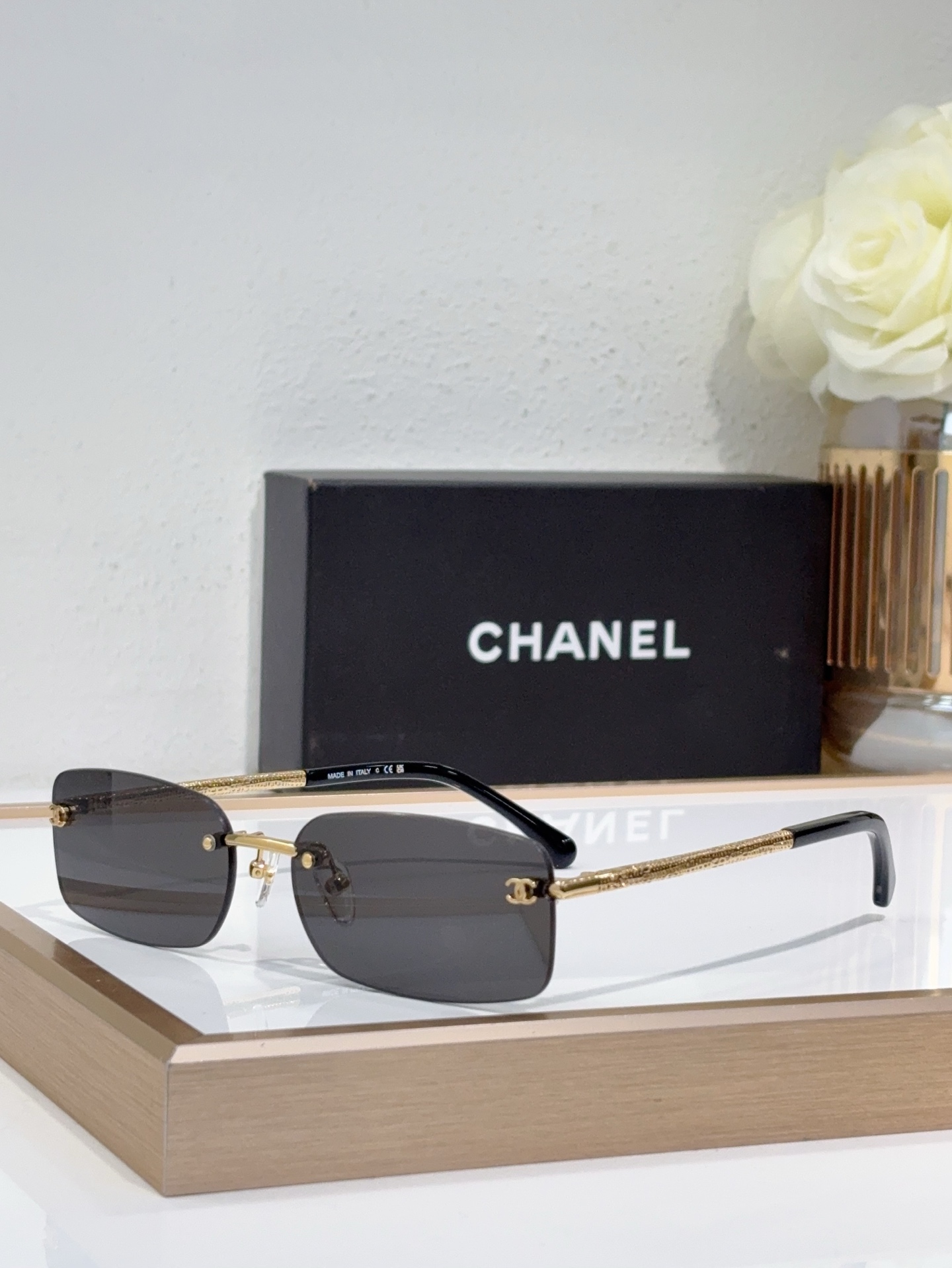 Chanel Rimless Rectangle Sunglasses with Silver CC Accents & Blue Lenses (Model: CH5538)