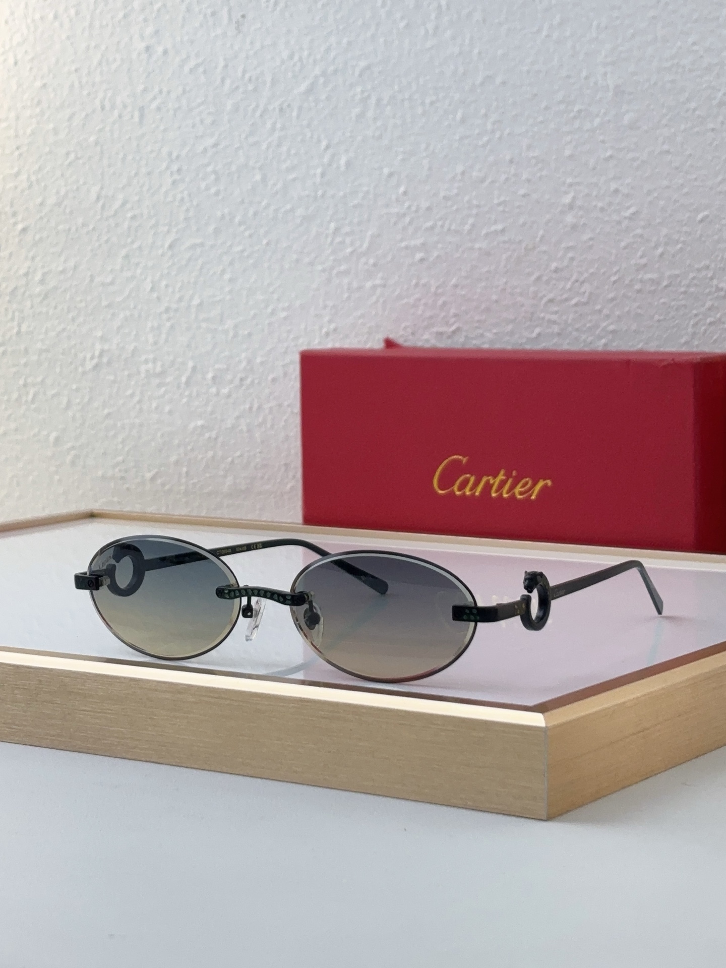 Cartier CT0648S Rimless Oval Sunglasses with Gold Ornamental Ring Accents